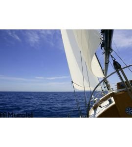 Sailboat sailing blue sea on sunny summer day Wall Mural