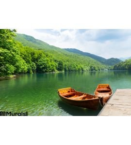 Wooden boats at pier on mountain lake Wall Mural